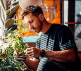 Indoor gardener tending to plants.